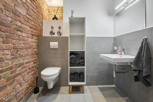 a bathroom with a white toilet and a sink at Central Apartment - Linienstraße in Berlin