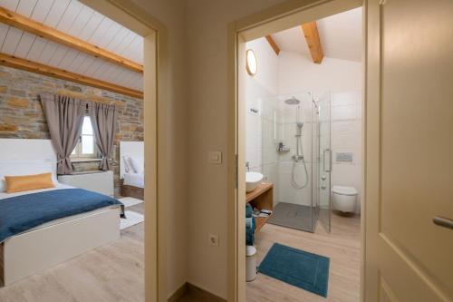 a bedroom with a bed and a bathroom with a shower at Villa Palazza in Pazin
