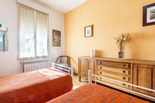 a bedroom with two beds and a dresser and a window at Zona Doctor Peset - B in Valencia