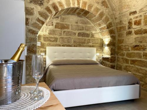a bedroom with a bed and a bottle of champagne at Casa Vacanze A un Passo dal Volo in Bari