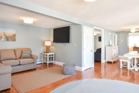 a living room with a couch and a tv at 400 Yards to the Beach Dogs Welcome in Dennis
