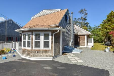 a small house in a yard with a driveway at 400 Yards to the Beach Dogs Welcome in Dennis