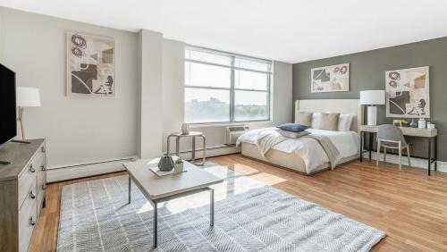 a bedroom with a bed and a table and a tv at Landing Modern Apartment with Amazing Amenities (ID1222X746) in Chicago