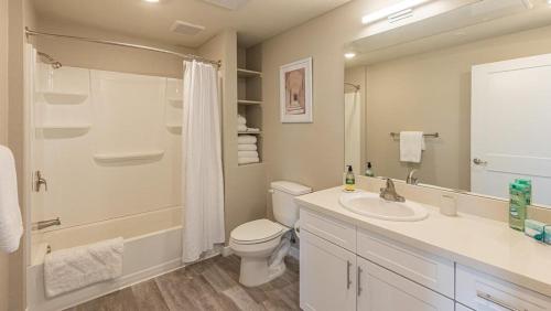a bathroom with a toilet and a sink and a mirror at Landing Modern Apartment with Amazing Amenities (ID7328X47) in Sparks