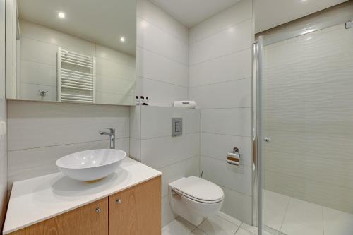 a bathroom with a sink and a toilet and a shower at Dom & House - Apartments Angielska Grobla - Self Check-in in Gdańsk
