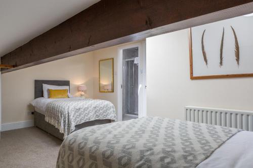 a bedroom with two beds and a window at Pattys Barn Holiday Cottages, Cabins and Venue Hire in Cockerham