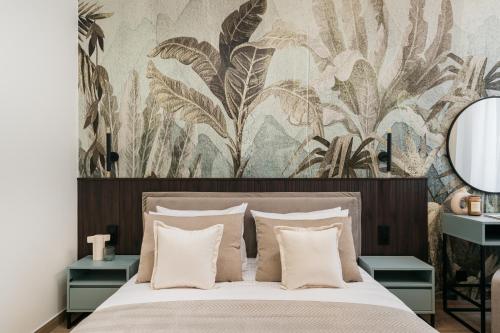 a bedroom with a large bed with a floral wallpaper at Muse - LoftAffair Spa Collection in Kraków