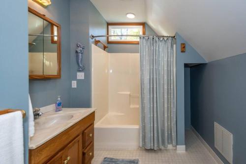 un baño con ducha y lavabo en Waterfront House with Private Dock and Fishing, en Reedville