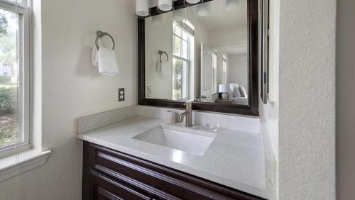 a bathroom with a sink and a mirror at Landing Modern Apartment with Amazing Amenities (ID4287X36) in Orlando