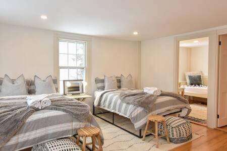 a bedroom with two beds and a television in it at Featured in Cape Cod Life Magazine in Barnstable