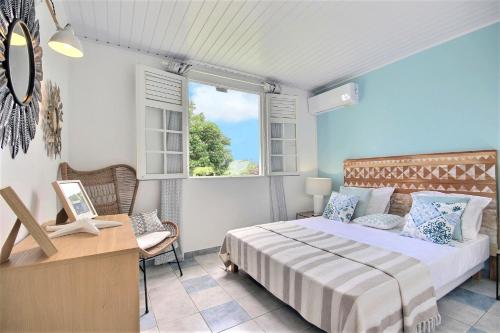 a bedroom with a bed and a desk and a window at Nature Paradise in Quartier Monplaisir