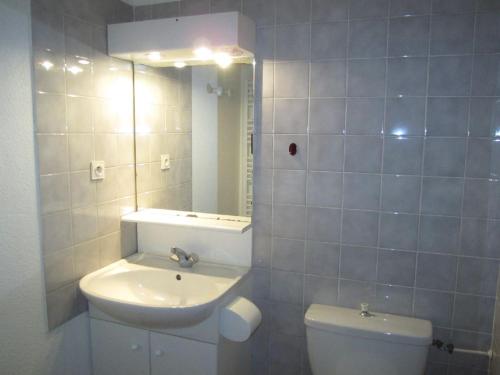 une salle de bain avec un lavabo, des toilettes et un miroir dans l'établissement Charmant studio avec balcon et parking - Proche centre et Thermes - 4 pers. - FR-1-512-79, à Brides-les-Bains