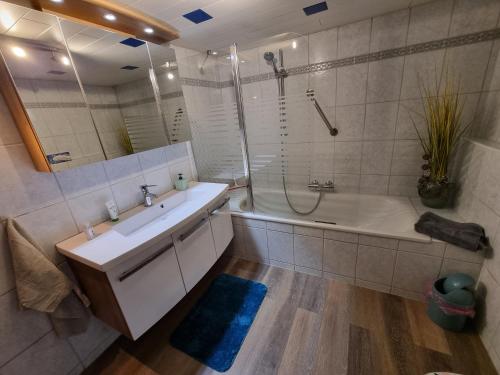 a bathroom with a tub and a sink and a shower at Schnuckelige Wohnung in Marl