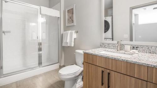 a bathroom with a shower and a toilet and a sink at Landing Modern Apartment with Amazing Amenities (ID1208X247) in Charlotte