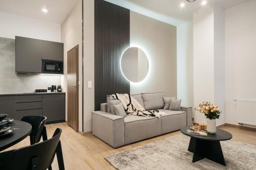 a living room with a couch and a table at Muse - LoftAffair Spa Collection in Kraków