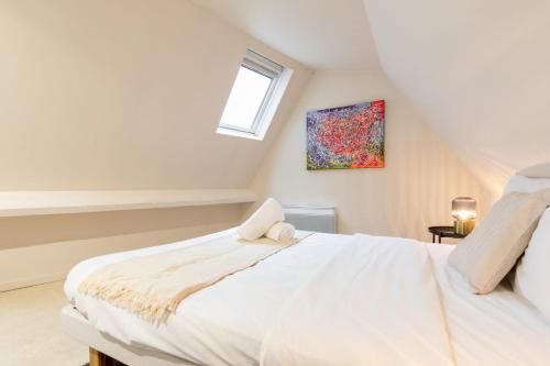 a bedroom with a white bed and a window at Old Lille - Superb apartment 2 bedrooms. in Lille