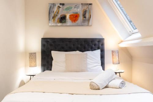 a bedroom with a bed with a black headboard at Old Lille - Superb apartment 2 bedrooms. in Lille