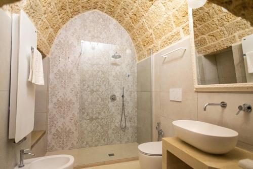 a bathroom with a shower and a sink at Palazzo Alma luxury rooms in Casarano