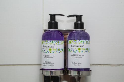 two bottles of disinfectants sitting next to each other at Gamma Puebla Señorial Centro in Puebla