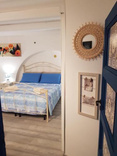 a bedroom with a bed and a mirror at Rosso Moro in Ragusa
