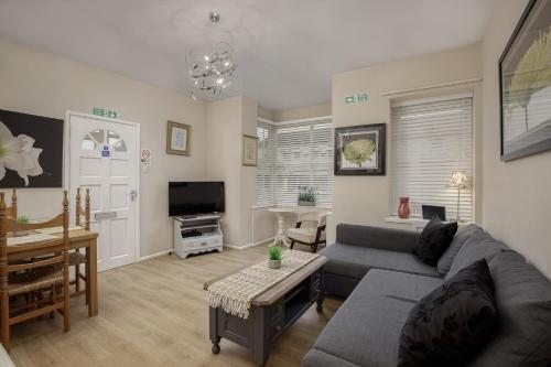 a living room with a couch and a table at Hornby Apartments in Blackpool