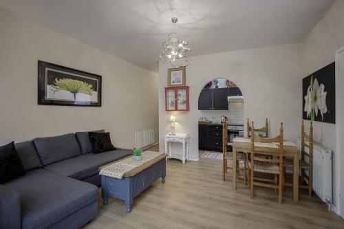 a living room with a couch and a dining room at Hornby Apartments in Blackpool