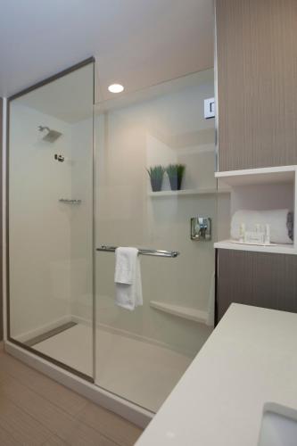a shower with a glass door in a bathroom at Courtyard by Marriott Houston City Place in Spring