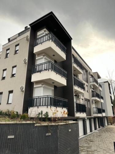 a building with balconies on the side of it at N Apartment in Vrnjačka Banja