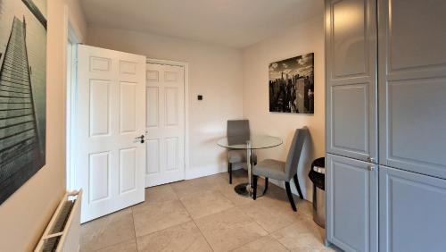 a small room with a table and a door at 2 minute walk to LUAS (tram) in Dublin