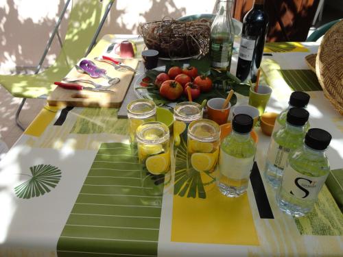a table with glasses of juice and fruit on it at Hôtel Punta e Mare des Chambres ou des Appartements T2 in Cargèse