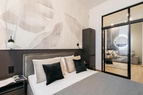 a bedroom with a bed with a large mirror at Muse - LoftAffair Spa Collection in Kraków