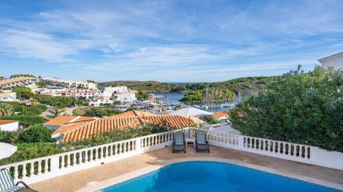 a view from the balcony of a villa with a swimming pool at Villa Alma de Mar - Exceptional Villa with Marina Views & Pool in Port d'Addaia