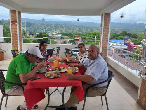 a group of people sitting at a table eating food at ROYALPARK in Venadillo