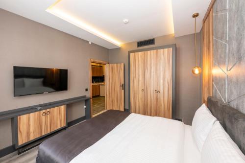 a bedroom with a bed and a flat screen tv at The Nirvanas Hotel in Istanbul