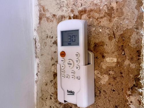 a remote control is attached to a wall at Casa Vacanze A un Passo dal Volo in Bari