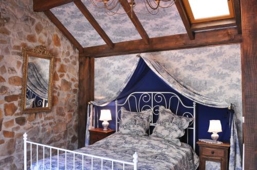 1 dormitorio con 1 cama con dosel azul en Le BASTIDON de CHANTE PIERRE, en Cuers