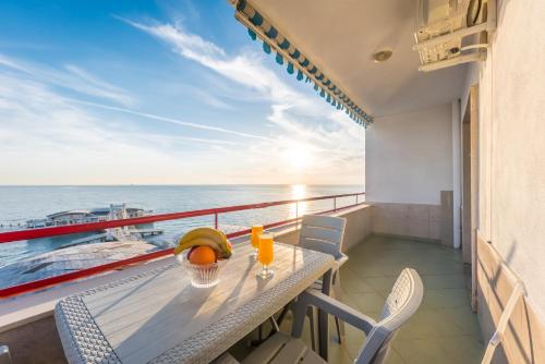 a table and chairs on a balcony with a view of the ocean at Full Sea View Center 2 Bedroom in Durrës