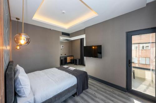 a bedroom with a bed and a large window at The Nirvanas Hotel in Istanbul