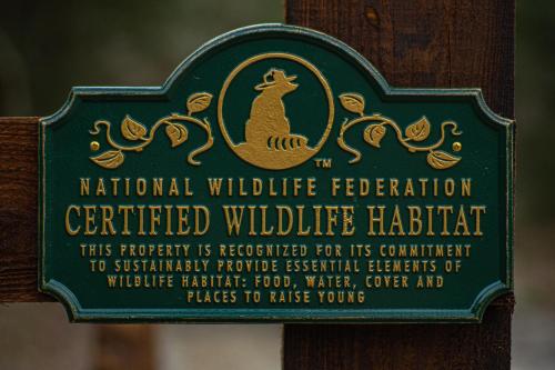 a sign for a wildlife federation certified wildlife habitat at Serenity at Natura in Magnolia