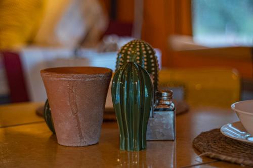 two green vases sitting on top of a table at Serenity at Natura in Magnolia