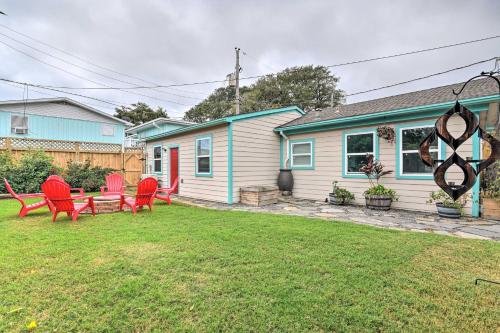a yard with red chairs and a house at Families, Groups, Pets! Galveston Gem 2 Mi to Sand in Galveston