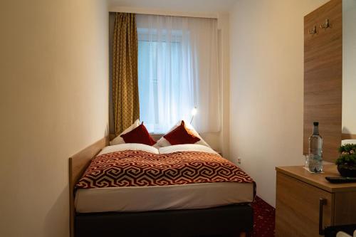 a bedroom with a bed in front of a window at Hotel Stadion Stadt in Hamburg