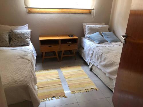 a bedroom with two beds and a nightstand between them at Casa Quebrada y Luna in La Rioja