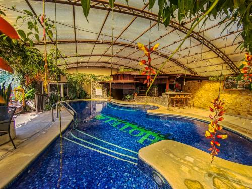 a large swimming pool in a building at Hotel & Spa Poco a Poco - Costa Rica in Monteverde Costa Rica