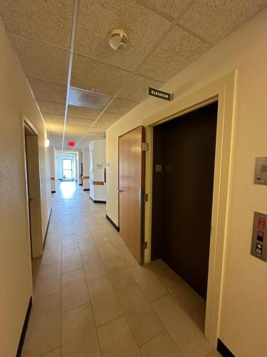 a hallway of an office building with a door and a hallwayngth at Peppermill Empress Inn in Centralia