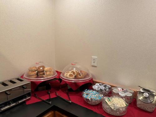 a counter with two trays of donuts and other food at Peppermill Empress Inn in Centralia