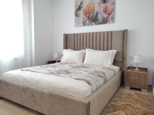 a bedroom with a large bed and two night stands at DLX03 - Appartement Deluxe 2 chambres - Centre Ville Oujda in Oujda
