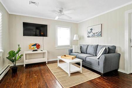 a living room with a couch and a table at Beachwalk #2 8 minute walk to the Beach in Virginia Beach