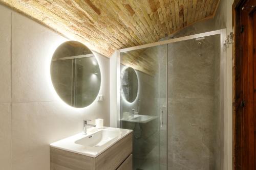 a bathroom with a sink and a shower and a mirror at La Piccola Corte in Spello