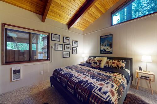 a bedroom with a bed and a wooden ceiling at Lookout Lair in Rhododendron